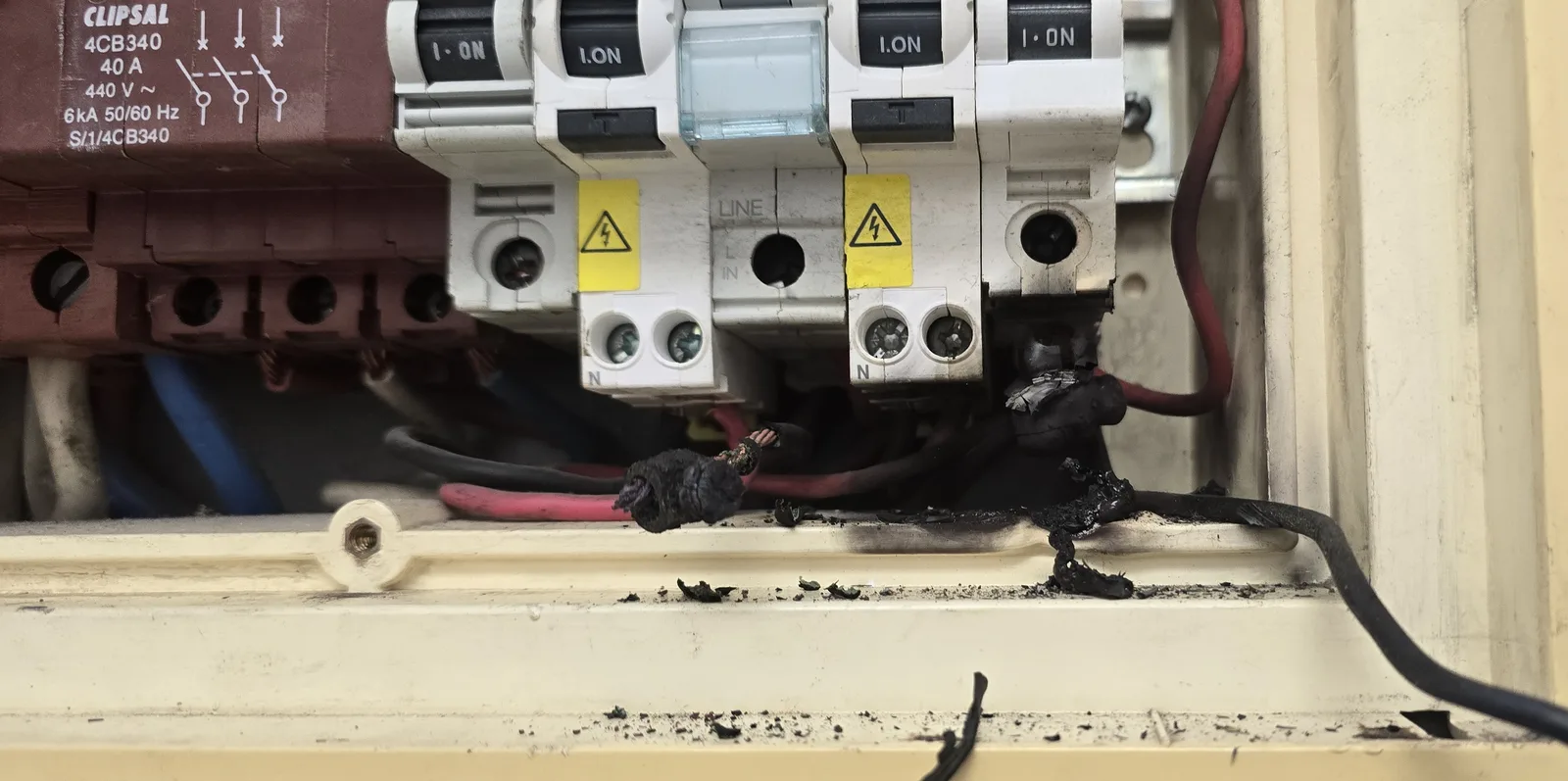 Before: burnt, melted wire connections and soot found inside an old switchboard during a Sawtell Contracting NT inspection