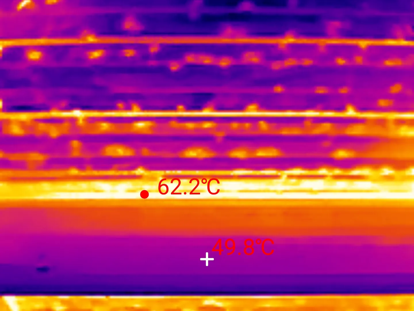 Thermal scan of an uninsulated metal roof deck, its hottest band reading 62.2 degrees Celsius with 49.8 degrees just below, taken in January